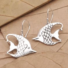 Inspired by the Moorish idol fish Bali's Putu Putri presents this pair of shining silver earrings. Crafted from sterling silver the whimsical earrings are designed with dainty details that emulate fish scales and fins. Sterling Silver Fish-shaped Jewelry, Silver Fish-shaped Earrings With Ear Wire, Silver Fish-shaped Earrings With Fish Hooks, Silver Fish-shaped Sterling Silver Earrings, Silver Sterling Fish-shaped Earrings, Nickel-free Silver Fish-shaped Earrings, Sterling Silver Fish Hook Earrings, Moorish Idol Fish, Moorish Idol