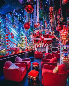 a room filled with red chairs and christmas decorations