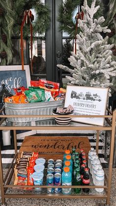 a bar cart filled with drinks next to a christmas tree and other holiday decorating items