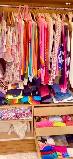 a closet filled with lots of colorful clothes