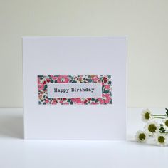 a birthday card with flowers on it