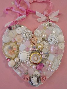 a heart shaped decoration with buttons and pearls