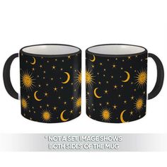 two black mugs with yellow stars and the moon on them, both have gold details