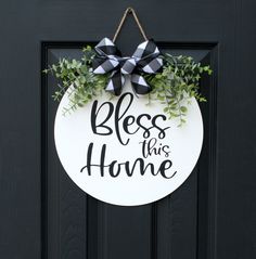 a door hanger that says,'bless this home'with a bow on it