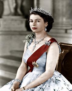 an old black and white photo of a woman in a tiara sitting on a bench