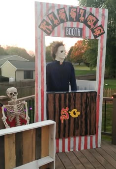 an outdoor halloween display with a skeleton in the mirror