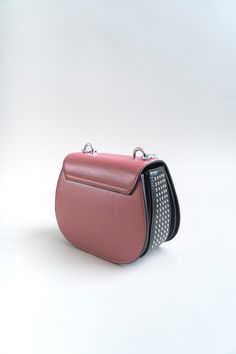 Who says pink can't be edgy? You'll love to make others blush with this stunning handbag. Carry it for a fashionable outing and let it do all the talking. Finished with this season's statement eyelets, this beauty can be worn over the shoulder with a longer adjustable strap, or in your hand with our chucky short chain. Smooth vegan leather. Attached silver chain accent with silver studs. Fabric lined interior Crossbody design with soft adjustable shoulder strap. Flap with magnetic snap closure. Animal Print Handbags, Printed Handbags, How To Look Classy, Weekender Bag, Snake Print, Silver Studs, Metal Chain, Snap Closure, Chain Link