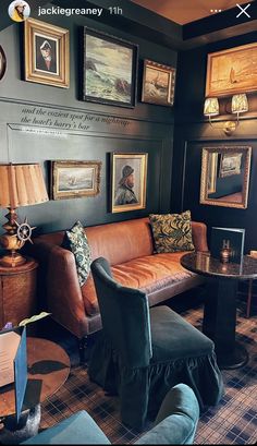 a living room filled with furniture and pictures on the wall