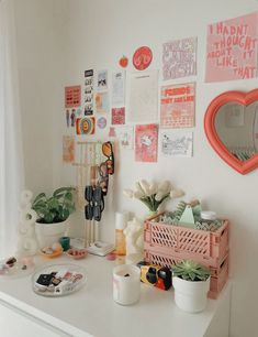 a white desk topped with lots of clutter