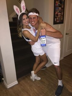 a man and woman in bunny ears hugging each other