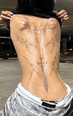 the back of a woman with tattoos on her body