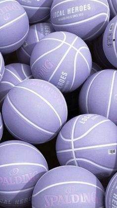 a pile of purple basketballs sitting next to each other