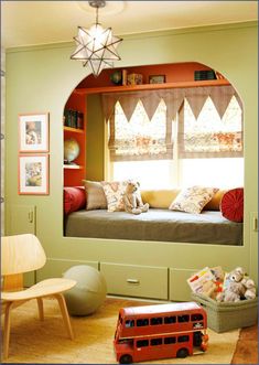 a child's bedroom with green walls and built in bookshelves