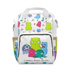 "Perfect for running errands or going on day trips with toddlers, this multi-purpose diaper backpack will fit everything from milk bottles to wet wipes to, you guessed it, diapers. It's made from lightweight, high-grade nylon to keep it sturdy for more than one generation. The open design has one main pocket with a zipper, three elastic pockets, and one net pocket for quick storage. .: 100% high-grade nylon .: One size:  15.0\" × 10.8\" × 6.7'' (38.1cm × 27.4cm × 17.0cm) .: Adjustable shoulder straps .: Padded back panel .: Cream interior lining" White Cartoon Backpack For Everyday Use, White Cartoon Print Bags For Back To School, Fun Rectangular Backpack For Everyday Use, Cute Travel Backpack With Cartoon Print, Cute Cartoon Print Backpack For Travel, Cute Cartoon Print Travel Backpack, Cartoon Style Travel Backpack Rectangular, Cartoon Style Large Capacity Bag For Travel, Cartoon Style Rectangular Backpack For Everyday