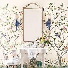 the bathroom is decorated with colorful wallpapers and floral designs, along with a white pedestal sink