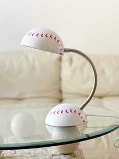 a glass table topped with a baseball lamp