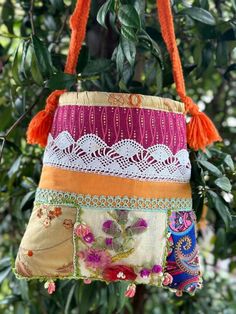 a colorful purse hanging from a tree