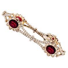 18KT White & Yellow Gold Rubelite & Diamond bracelet with floral motif. This gorgeous piece is adorned with 4 Oval Cut Rubellite for a total approximate weight of 10.00 carats and 148 Round Cut Diamonds for a total approximate diamond weight of 2.12 carats. The bracelet measures 7.25 inches long and weighs 25.8 grams. Jewelry Necklace Simple, Simple Diamonds, Floral Bracelet, Bracelets Gold Diamond, White Gold Bracelet, Rose Jewelry, Pretty Bracelets, Fine Jewelry Bracelets, Play Dress