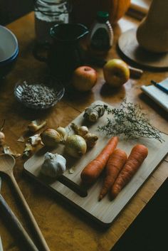 carrots and garlic on a wooden cutting board