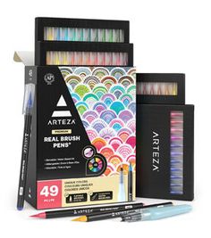 the artiza real brush pens are set up in a box with markers and pencils