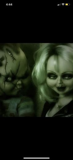 two creepy looking dolls are next to each other