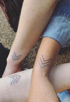 two people with matching tattoos on their legs