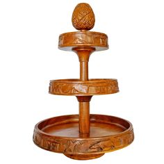 a wooden three tiered tray with an animal on it's top and bottom