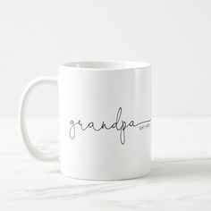 a white coffee mug with the word grandpa written in cursive writing on it