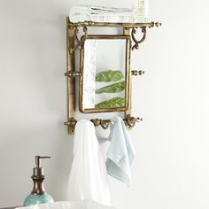 a bathroom sink with a mirror above it and towels hanging on the wall next to it