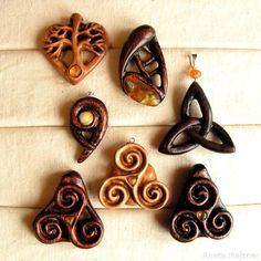 six wooden pendants with designs on them