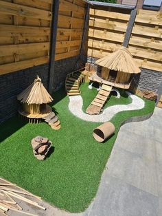 an outdoor play area with grass and wooden structures