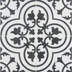 a black and white tile with an ornate design