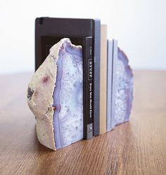 a bookend made out of two books sitting on top of a wooden table