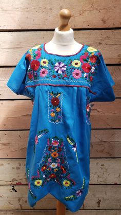 a blue dress with colorful flowers on it