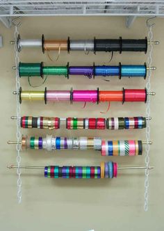 an image of some colorful spools hanging on the wall with text that reads, 33 clever ways to organize all