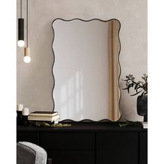 a mirror sitting on top of a black dresser