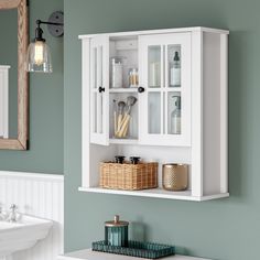 Functionality meets style with this charming two-door wall cabinet. Featuring two glass doors with windowpane-styling and one open shelf, this cabinet can be hung in the bathroom above the toilet or in the laundry room above the sink to add a touch of stylish storage without sacrificing floor space. Double doors open to reveal two interior fixed shelves perfect for storing extra toilet paper, washcloths, and more, then close gently with their soft-close hinges. Use the open shelf below to display your favorite home accessories. To customize the look, add the knob color of your choice to the doors (polished silver and black options included). Includes detailed instructions for easy assembly and wall mounting. Pair with any of the additional RiverRidge Home Danbury Collection items to add be Bathroom Wall Cabinet Above Toilet Hardware, Cabinet Over Toilet Ideas, Bathroom Wall Cabinet Ideas, Cabinet Functionality, Above The Toilet Ideas, Above Toilet Storage Cabinet, Toilet Ideas, Wall Storage Cabinets, Bathroom Store