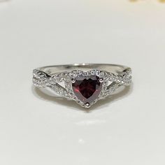 Sterling Silver Heart cut Garnet & White Topaz Ring....Marked 925...Total of weights 2.2gramsMeasure of Face 7.6MM...It's in very good condition. Sterling Silver Heart Cut Topaz Promise Ring, Sterling Silver Heart-shaped Diamond Cut Rings, Heart-shaped Sterling Silver Rings With Diamond Cut, Heart Shaped Sterling Silver Rings With Diamond Cut, Anniversary Heart Cut Topaz Ring In Sterling Silver, Heart-shaped Topaz Promise Ring, Heart Cut Topaz Gemstone Ring For Promise, Heart Cut Topaz Promise Ring, Heart Cut Topaz Ring For Promise