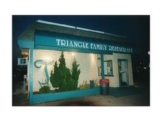 the front entrance to triangle family restaurant at night