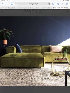 a green couch sitting on top of a wooden floor