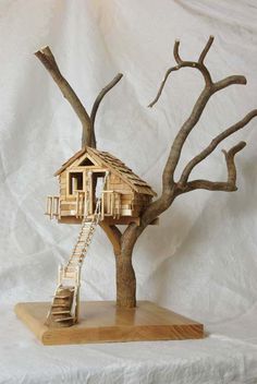 a wooden tree house with stairs to the roof