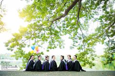 a group of young women sitting next to each other under a tree