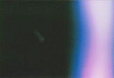 a blurry image of an apple computer with the screen turned green and blue, as if it were taken from above