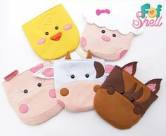 five different animal shaped oven mitts on a white surface