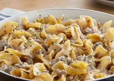 a bowl filled with pasta and meat on top of a table