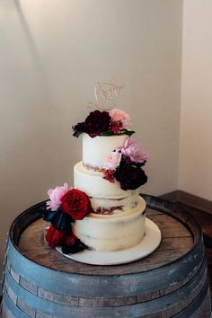 a wedding cake sitting on top of a barrel