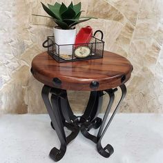 a small wooden table with some plants on it