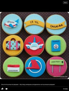 decorated cookies with different types of travel related items on top of each cookie, including an airplane and luggage tag