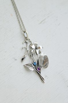 ITEM DESCRIPTION: The size H 5 cm x W 3 cm (2 x 1 1/3 inch). Weight - 3 g. You can buy it with a silver chain or without it. This spring flower is so delicate. So I was inspired by nature and made a wild violet flower of sterling silver, amethyst, and blue zircon. This is a very detailed handmade necklace. This floral jewelry will be a great addition to your jewelry collection or gift for someone whose you love. This handmade necklace will come to you in a gift box - ready for gifting. The parce Violet Flower Necklace, Viola Flower, Handmade Silver Jewellery, Floral Jewelry, Silver Jewelry Necklace, Floral Pendant, Violet Flower, Nature Inspired Jewelry, Garden Flower