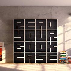 a living room with bookshelves and a couch in front of a large poster